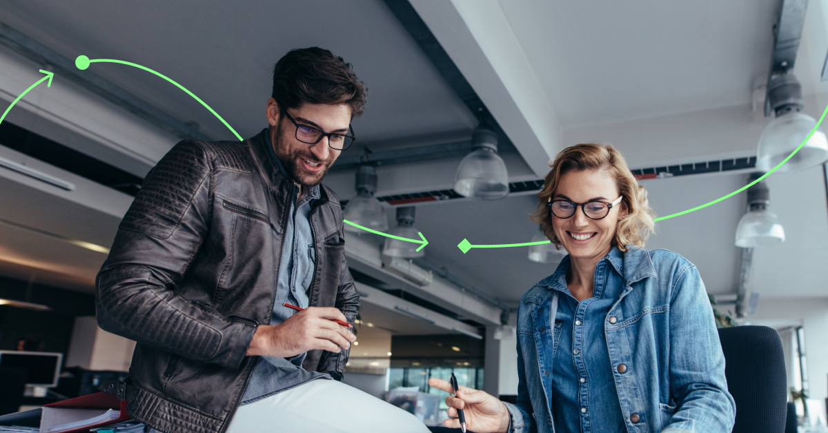 Lifestyle image of two employees in the office collaborating.